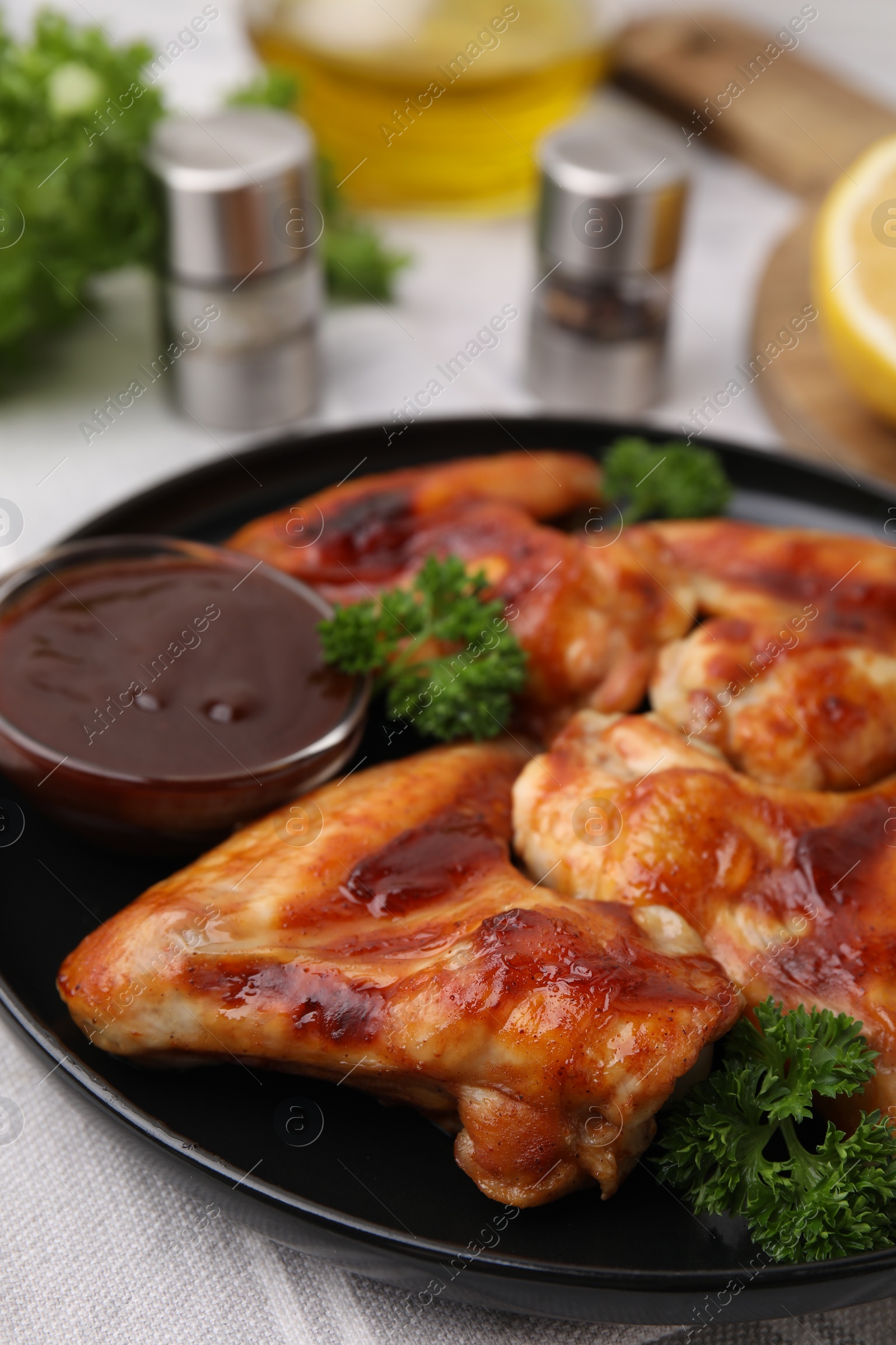 Photo of Fresh marinade and chicken wings on table, closeup