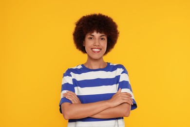 Portrait of happy young woman on orange background