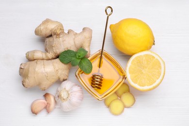 Different natural cold remedies on white wooden table, flat lay. Cough treatment