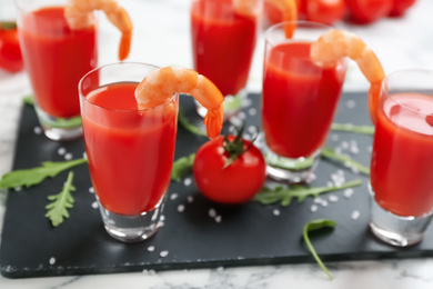 Photo of Shrimp cocktail with tomato sauce served on slate board