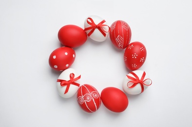 Photo of Frame made of red painted Easter eggs on white background, space for text