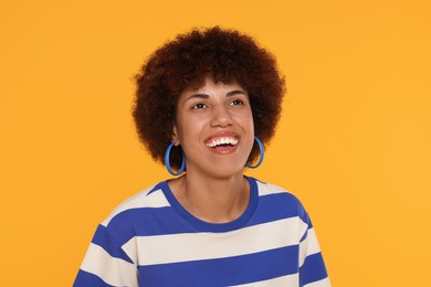 Photo of Portrait of happy young woman on orange background