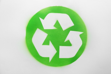 Recycling symbol painted on white paper, top view