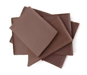 Photo of Pieces of tasty dark chocolate bar on isolated white, top view