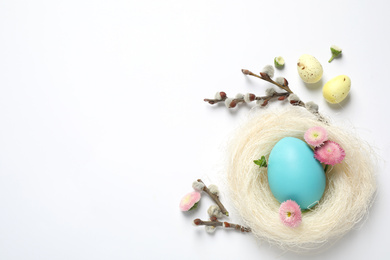 Photo of Flat lay composition with Easter eggs on white background. Space for text