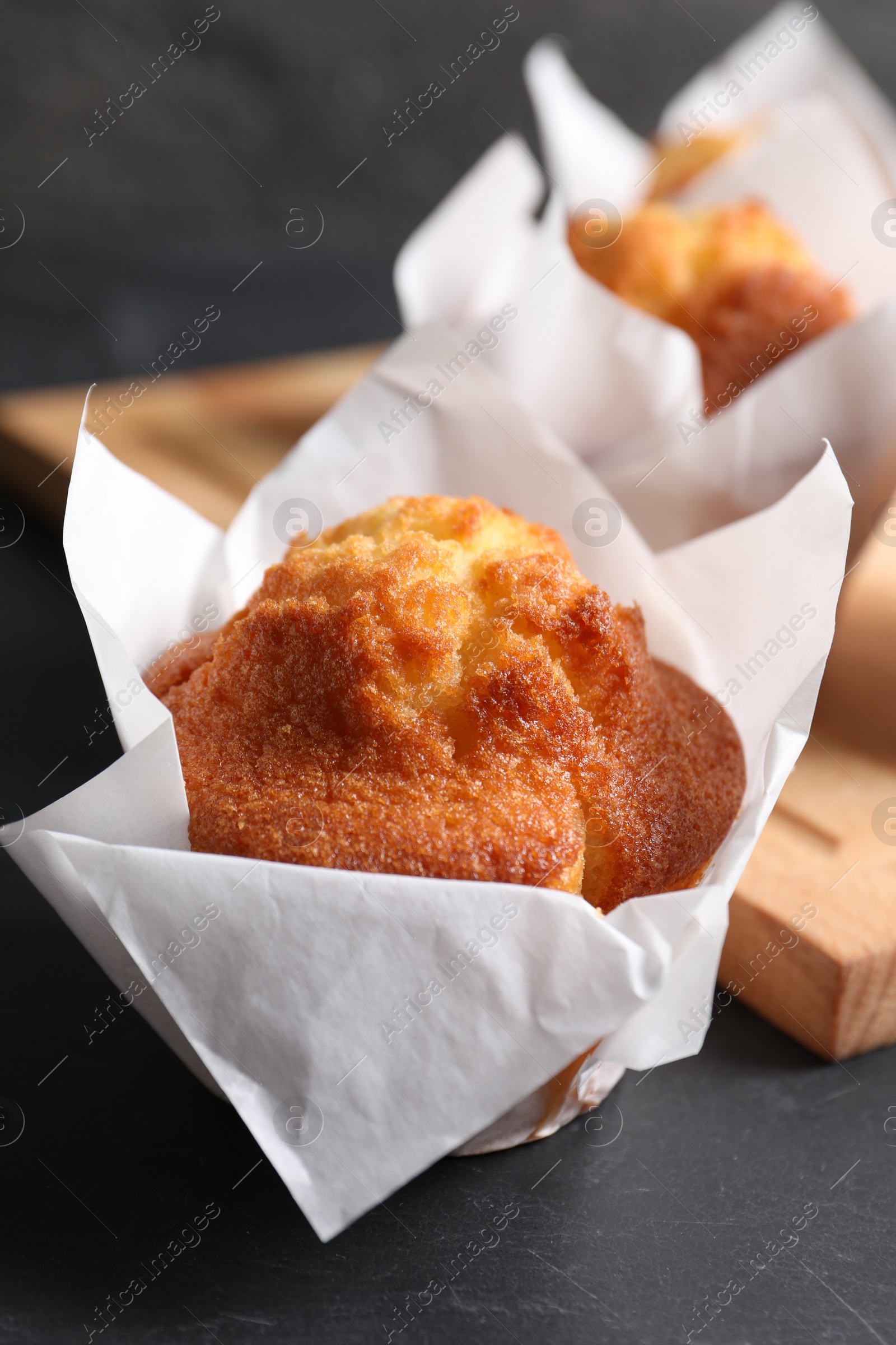 Photo of Tasty muffin on grey table, closeup. Fresh pastry