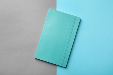 New stylish planner with hard cover on color background, top view