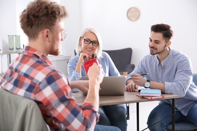 Photo of Business people interviewing candidate in office. Professional communication