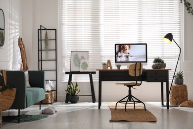 Stylish home office interior with sofa and comfortable workplace