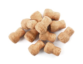 Heap of sparkling wine corks on white background, top view