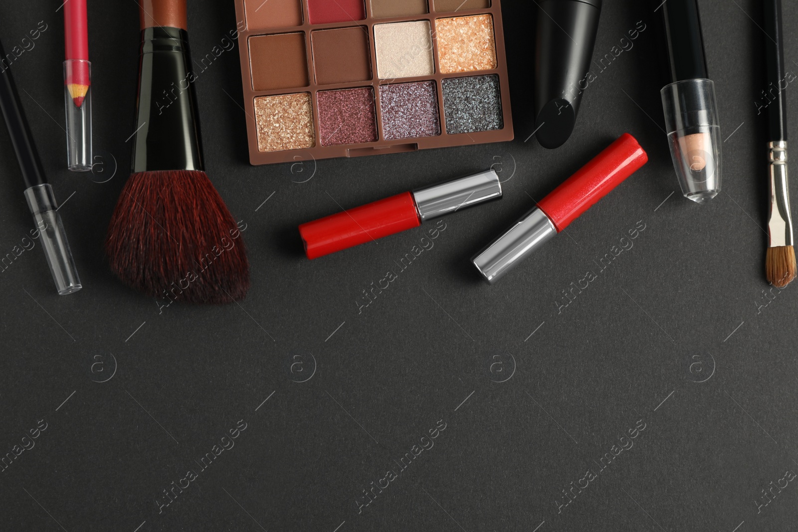 Photo of Set of makeup products on dark background, flat lay. space for text