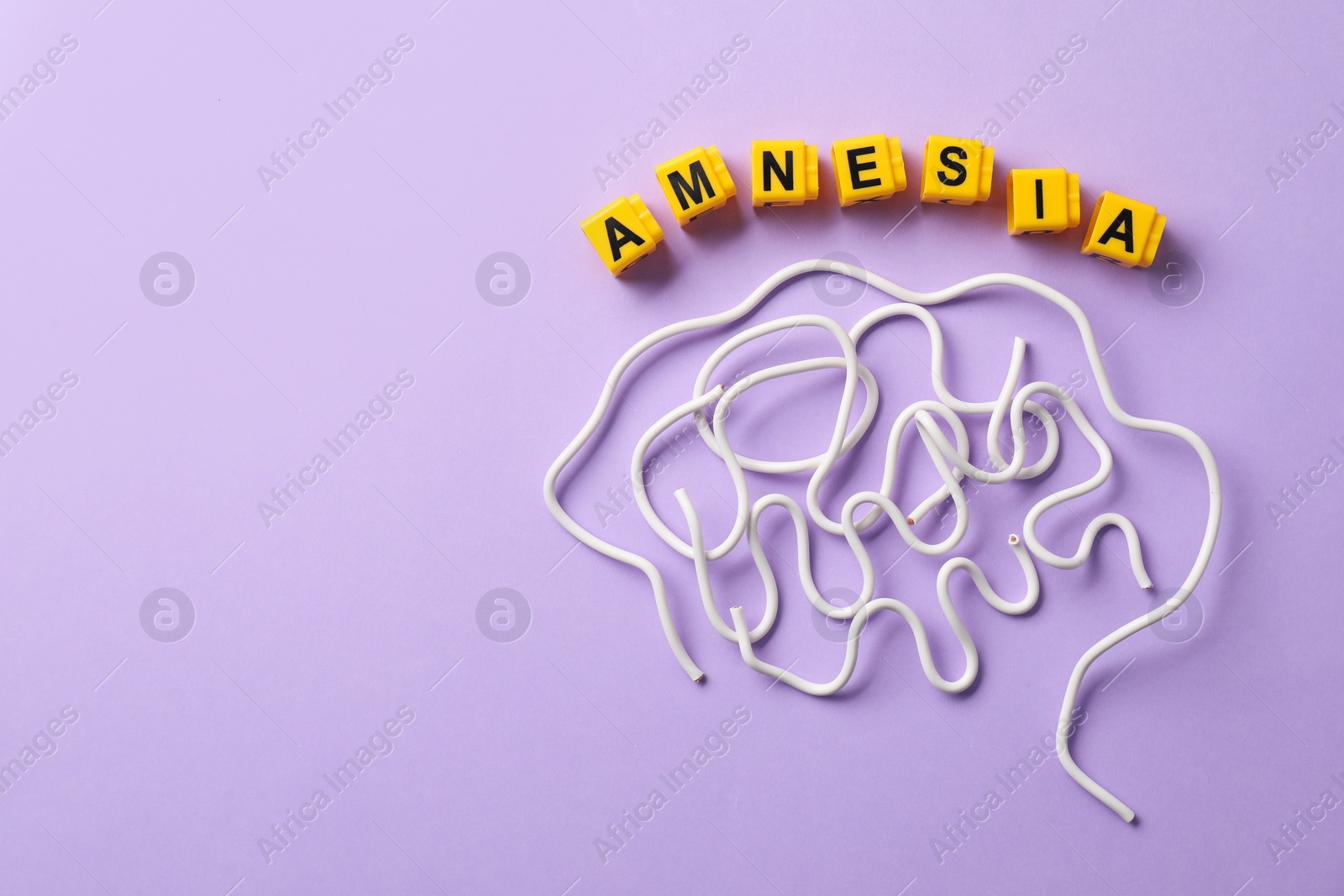 Photo of Word Amnesia and brain made of wires on violet background, flat lay. Space for text