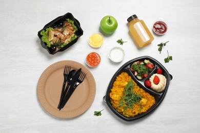 Photo of Flat lay composition with lunchboxes on white table. Healthy food delivery