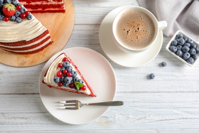 Photo of Delicious homemade red velvet cake served with coffee on table, flat lay