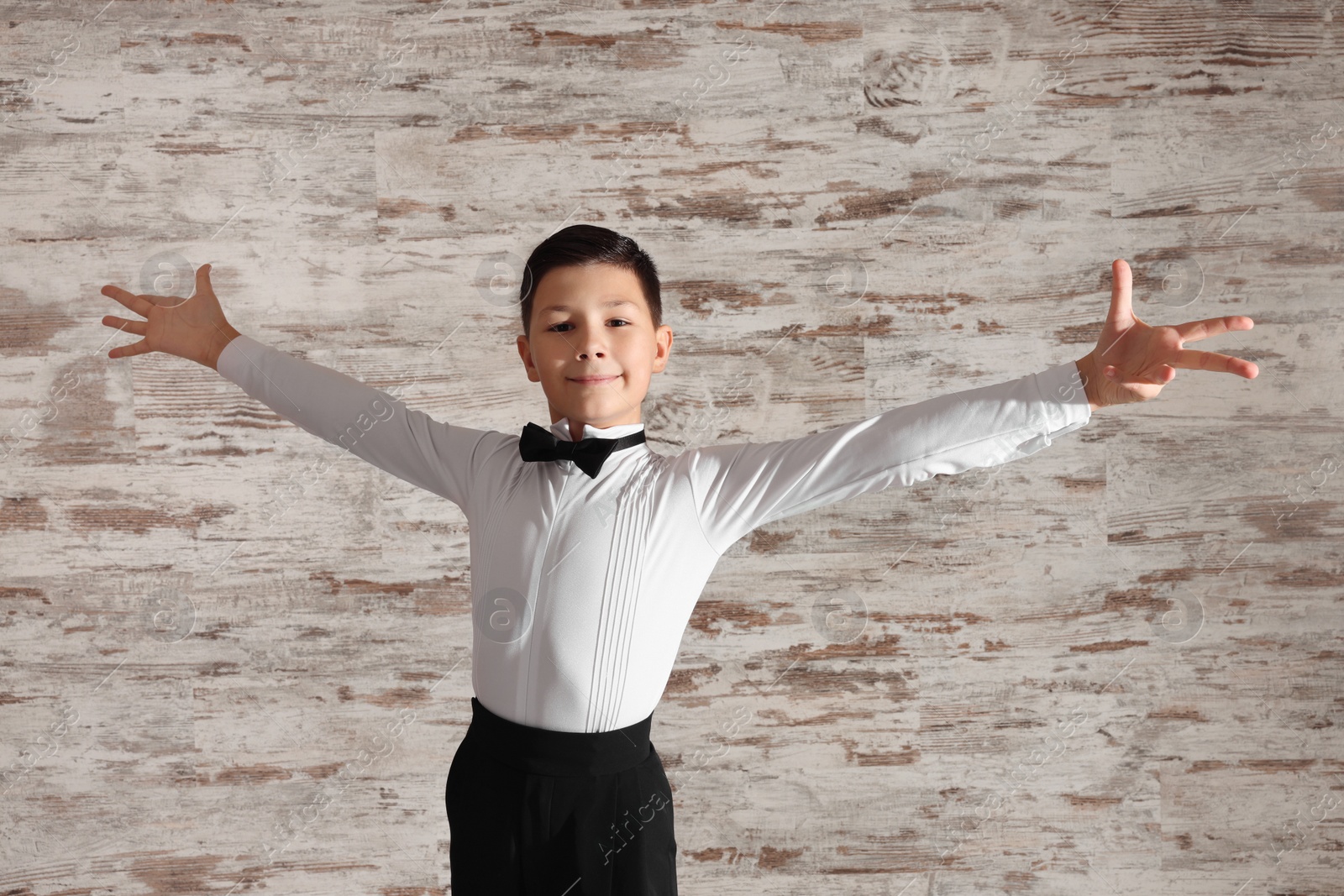 Photo of Beautifully dressed little boy dancing in studio