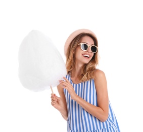 Happy young woman with cotton candy on white background