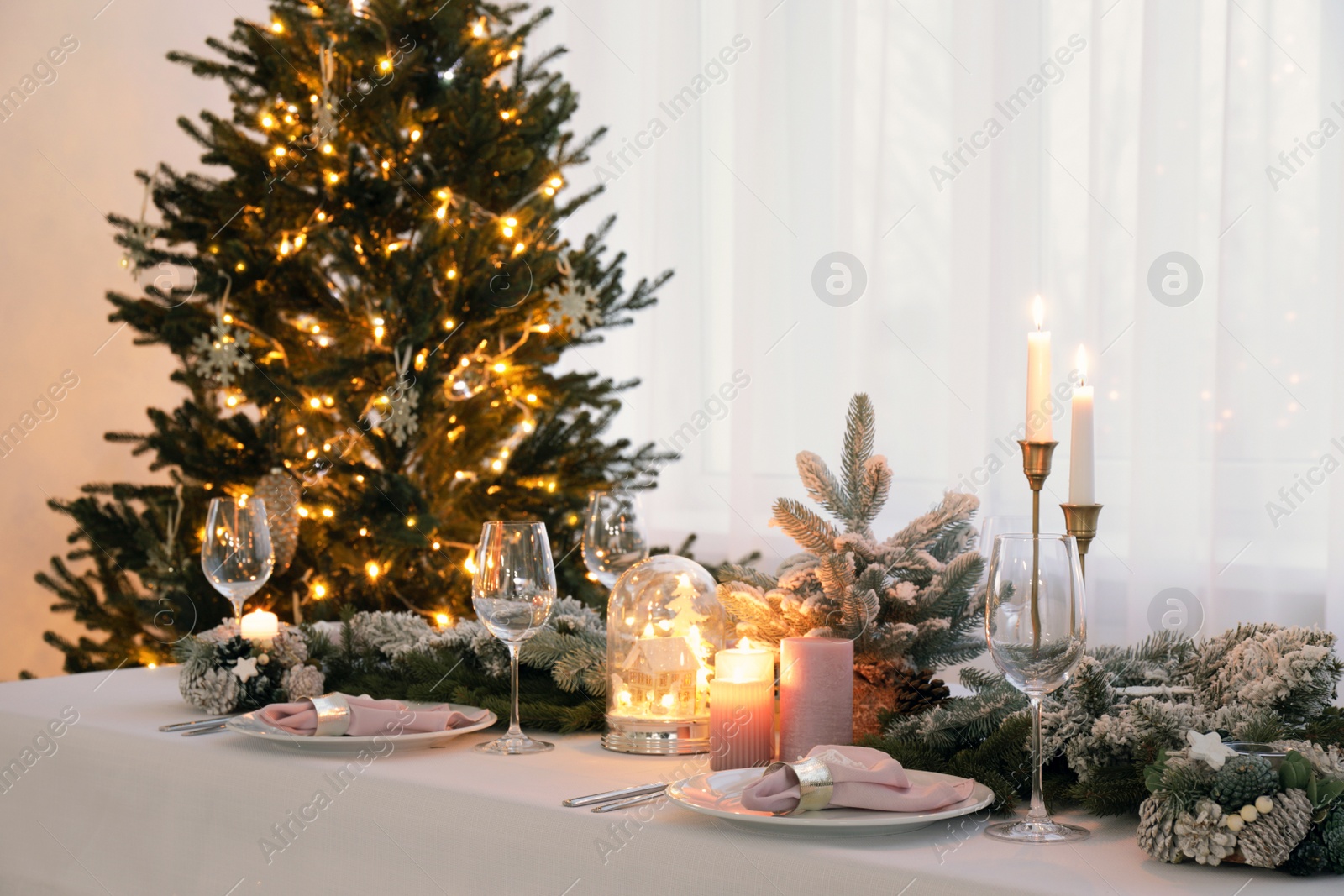 Photo of Beautiful festive table setting with Christmas decor in room