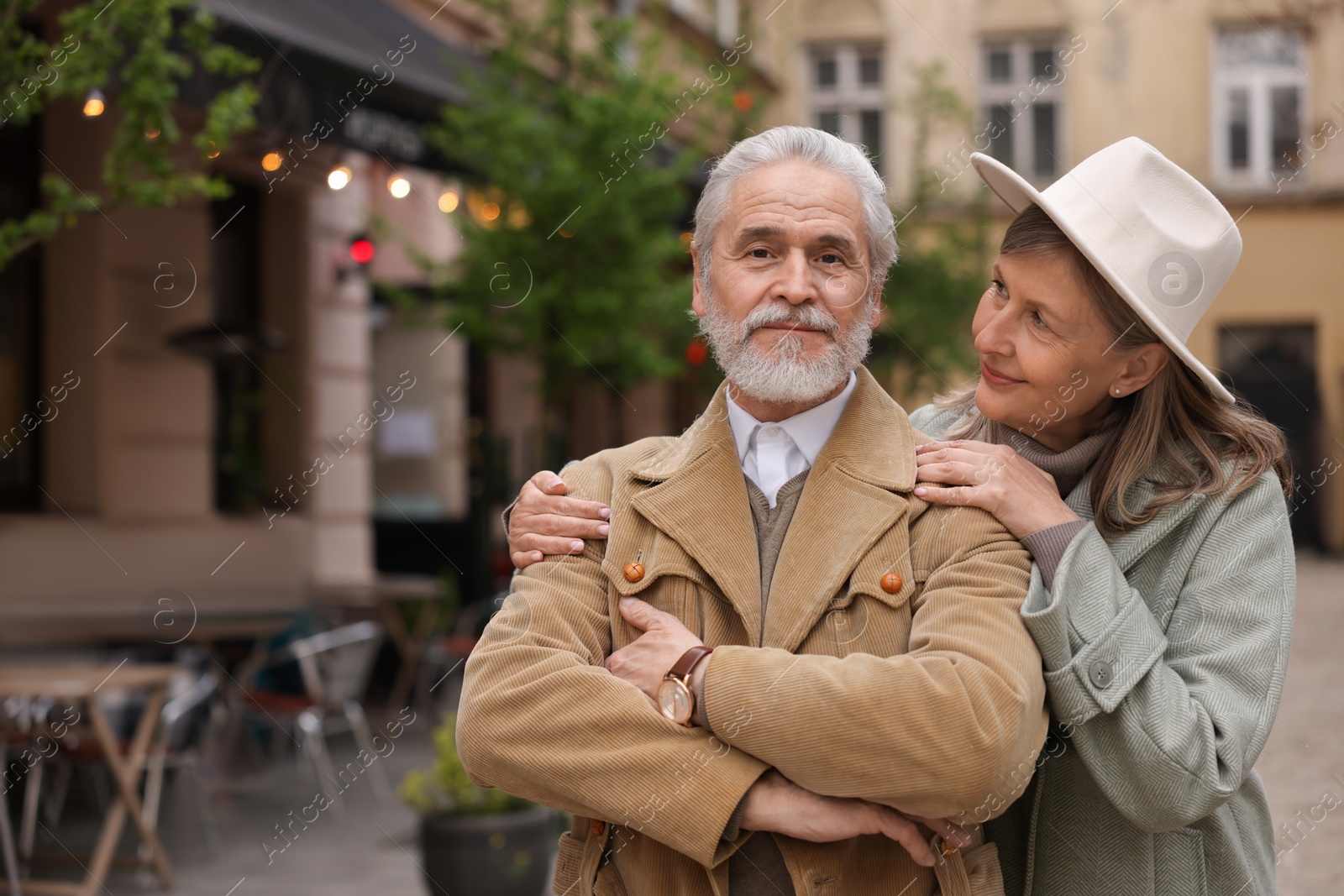 Photo of Portrait of affectionate senior couple walking outdoors, space for text