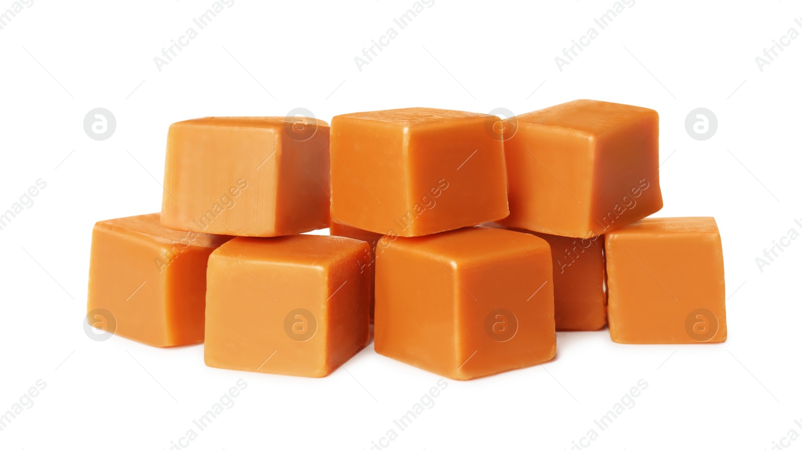 Photo of Many caramel cubes on white background. Confectionery