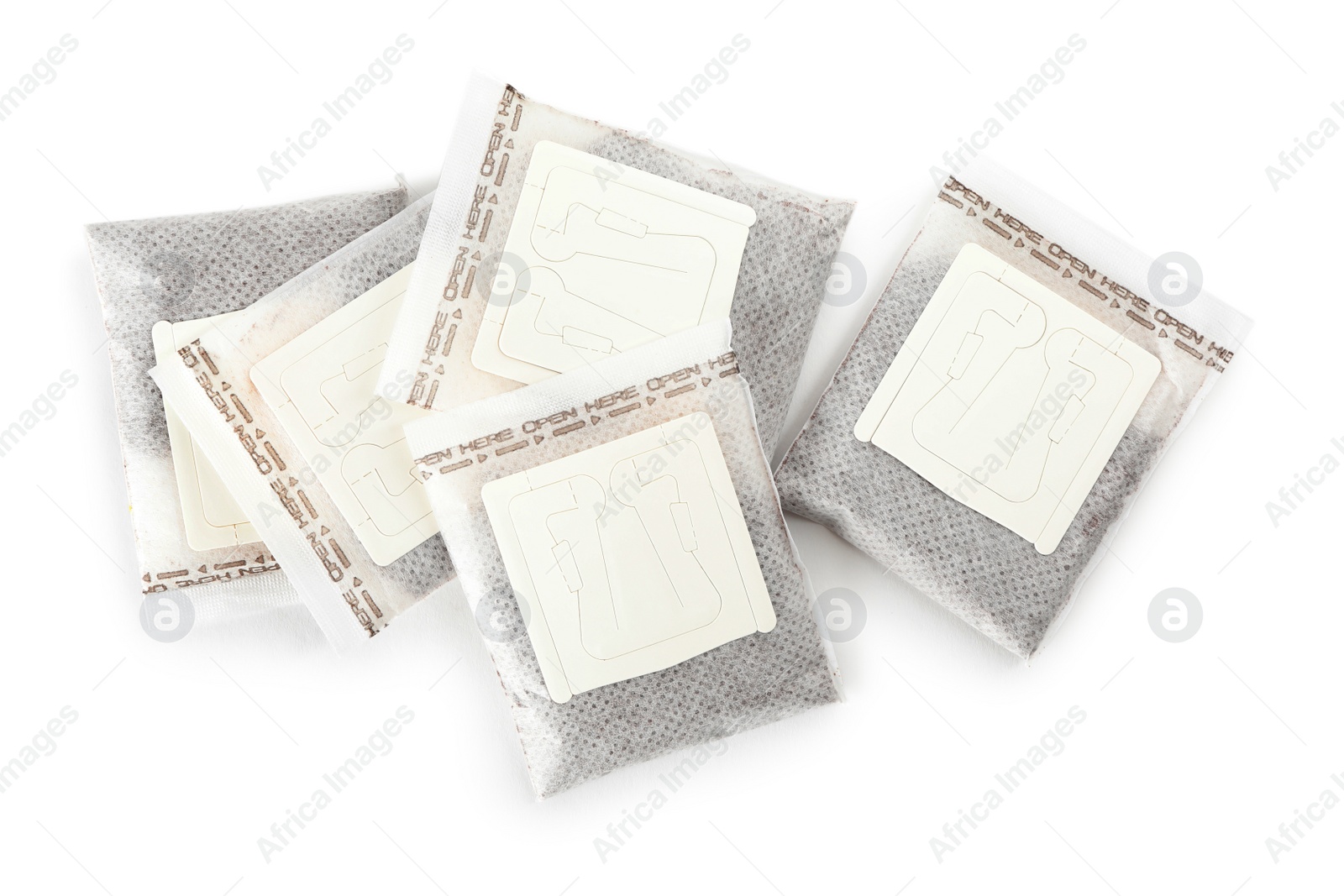 Photo of Drip coffee paper bags isolated on white, top view