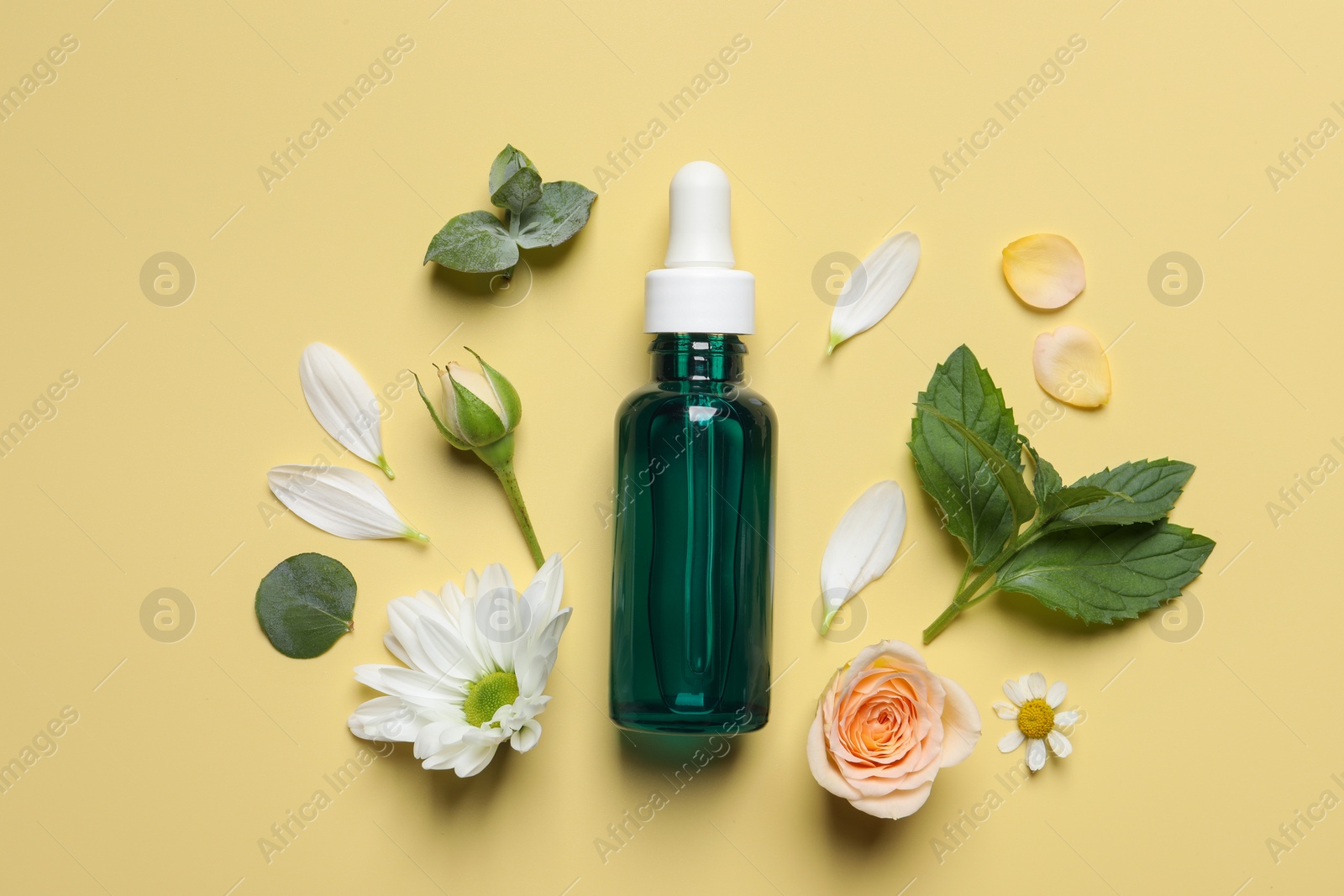 Photo of Flat lay composition with cosmetic serum on pale yellow background