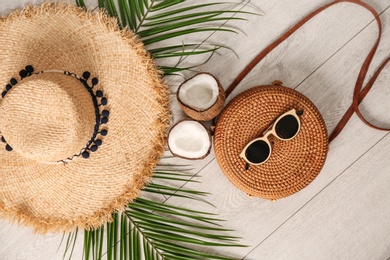 Photo of Flat lay composition with bamboo bag and straw hat on wooden background