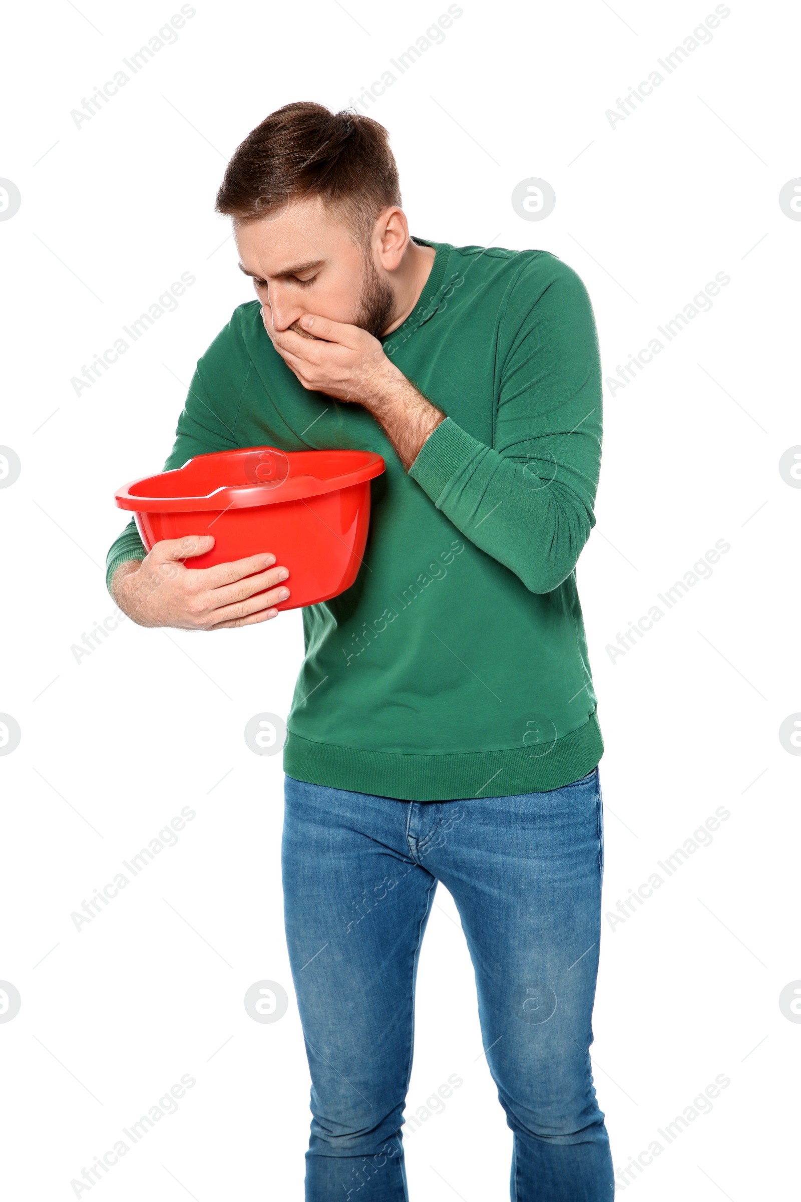 Photo of Young man with basin suffering from nausea isolated on white