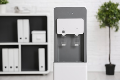 Photo of Modern water cooler in stylish office interior