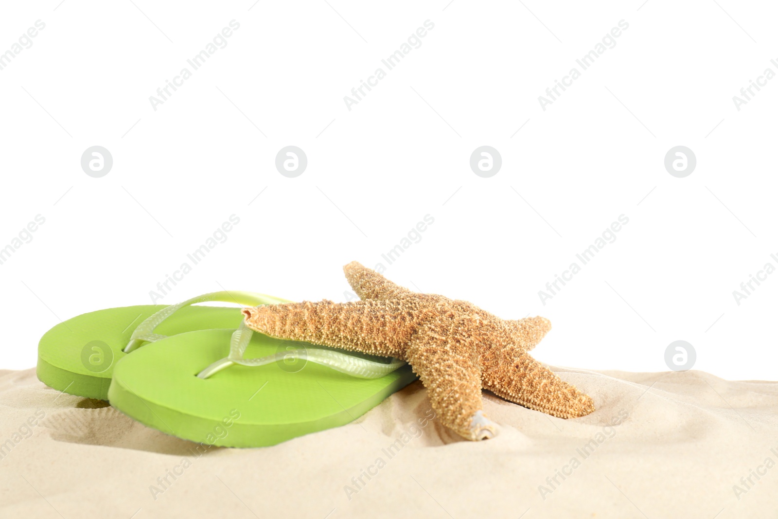 Photo of Flip flops and starfish on sand against white background. Beach accessories