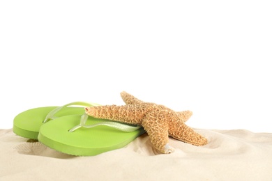 Photo of Flip flops and starfish on sand against white background. Beach accessories