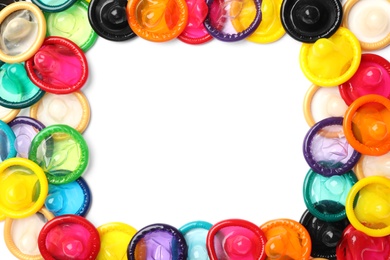 Frame made of colorful condoms on white background, top view with space for text. Safe sex