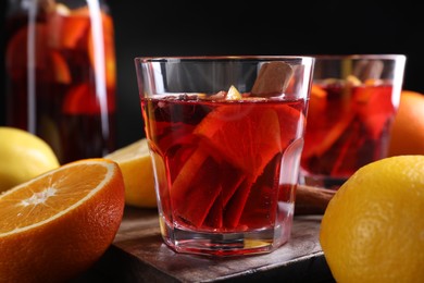 Photo of Aromatic punch drink and ingredients on table, closeup