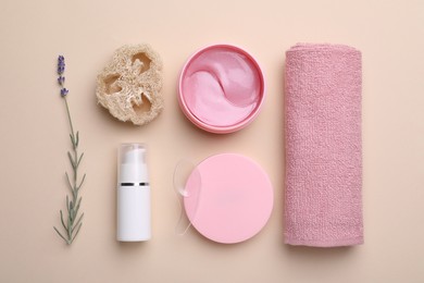 Flat lay composition with under eye patches on beige background. Cosmetic product