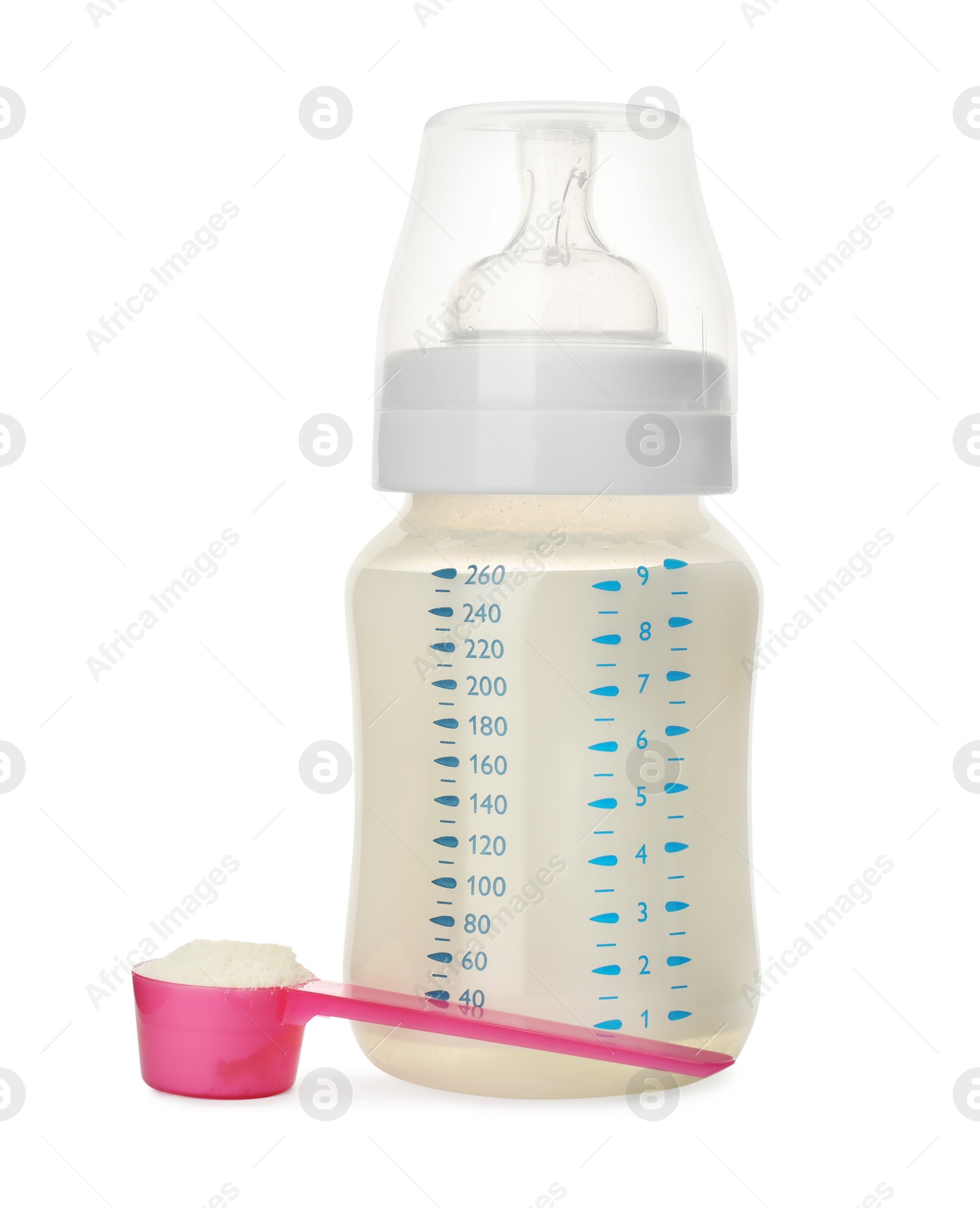 Photo of Feeding bottle with infant formula and scoop of powder on white background. Baby milk