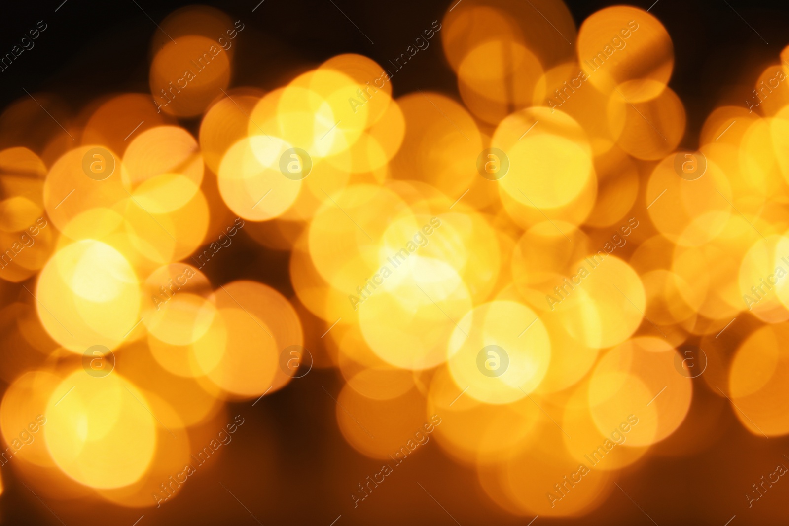 Photo of Gold glitter with bokeh effect on dark background