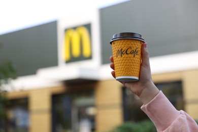 Photo of Lviv, Ukraine - September 26, 2023: Woman with hot McDonald's drink outdoors, closeup. Space for text