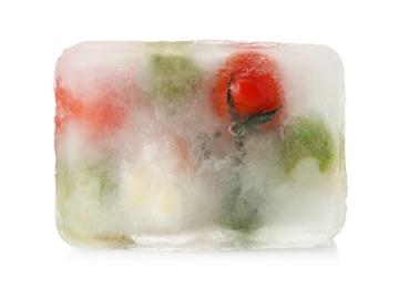 Photo of Fresh vegetables frozen in ice cube on white background