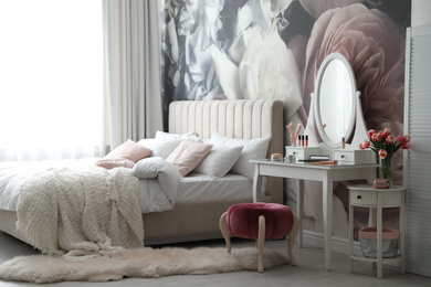 Stylish bedroom interior with elegant dressing table and floral wallpaper