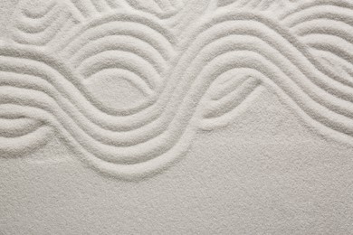 White sand with pattern as background, top view. Zen concept