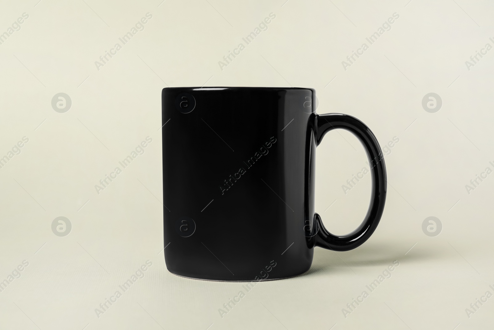 Photo of One black ceramic mug on light grey background