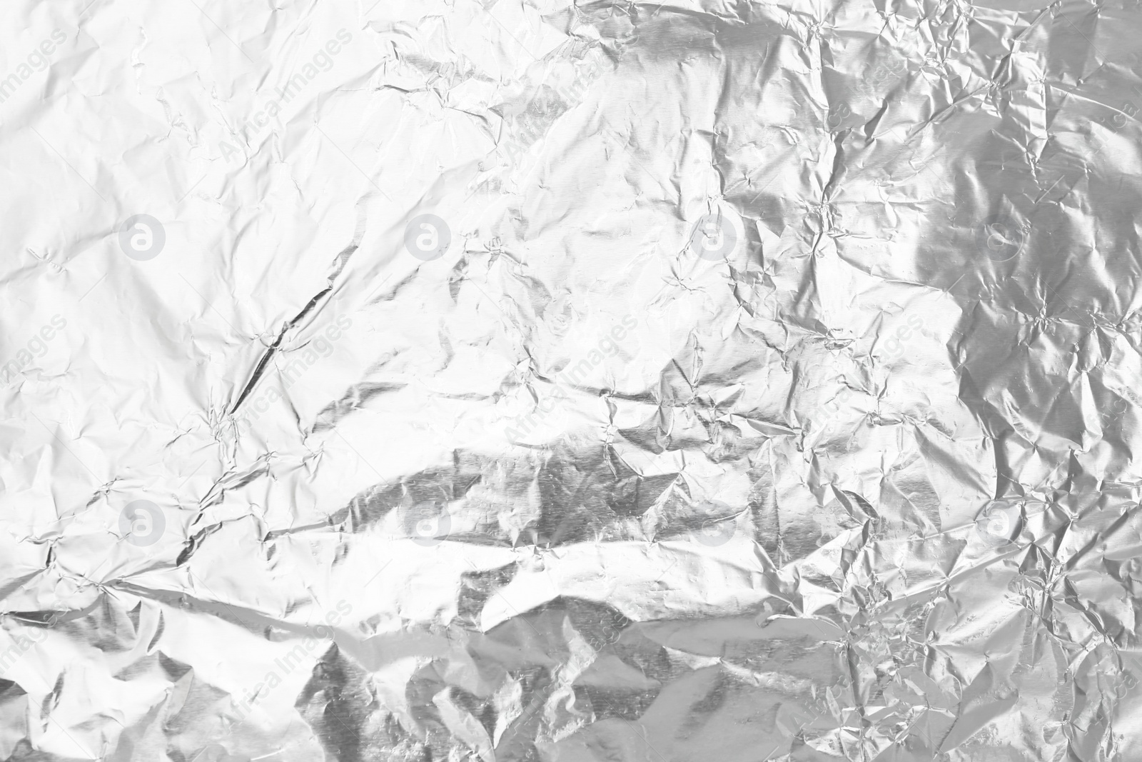 Photo of Crumpled silver foil as background, top view