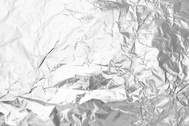 Photo of Crumpled silver foil as background, top view