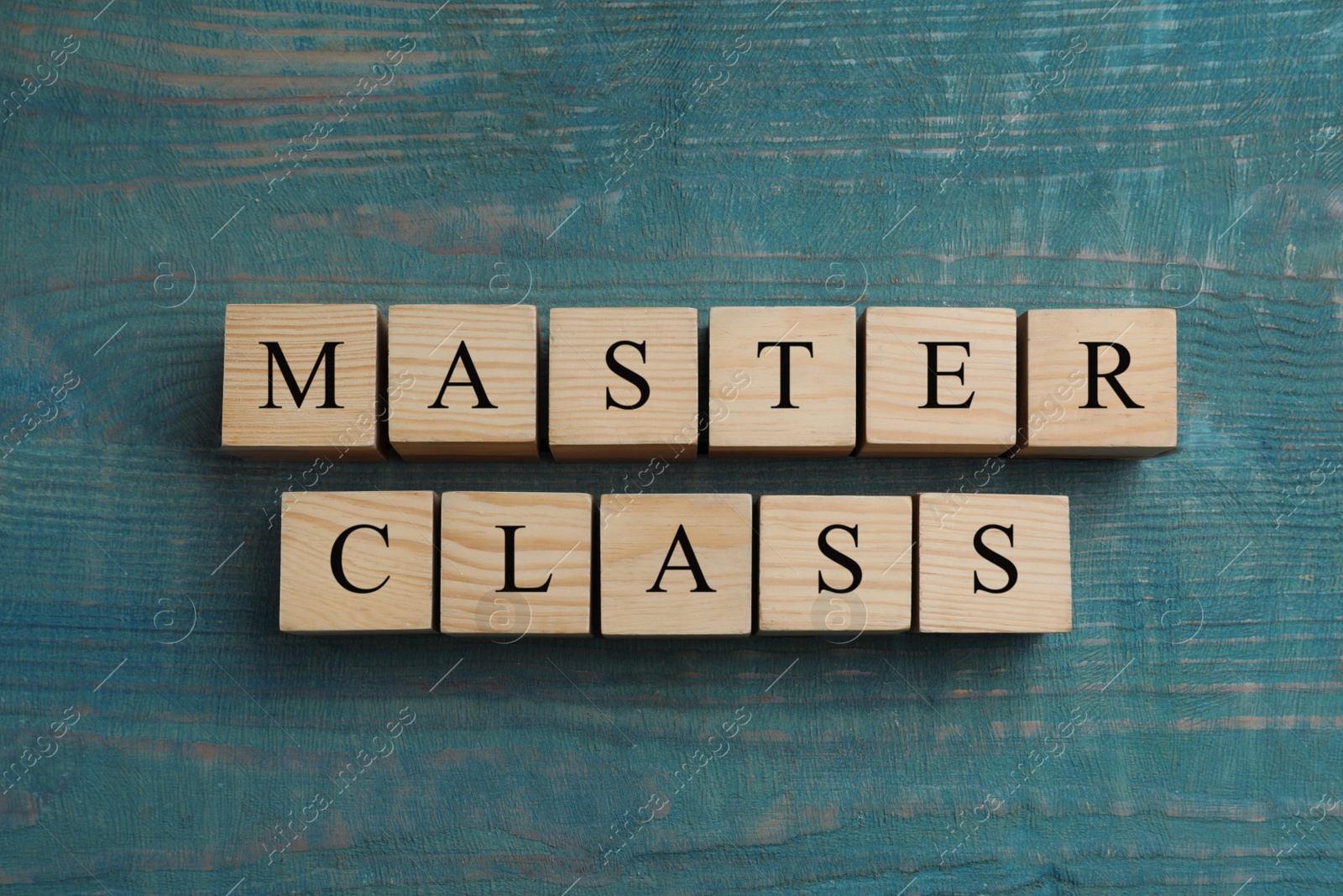 Photo of Wooden cubes with words Master Class on light blue table, flat lay