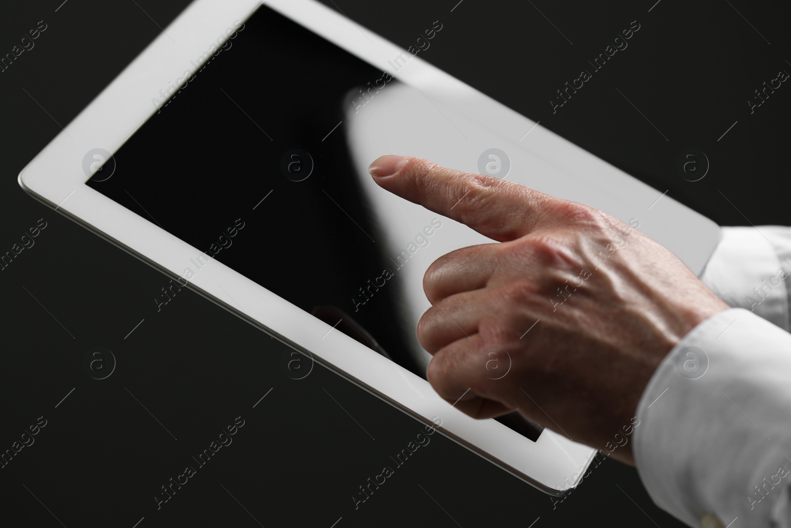 Photo of Closeup view of man using new tablet indoors