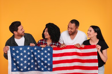 Photo of 4th of July - Independence Day of USA. Happy friends with American flag on yellow background