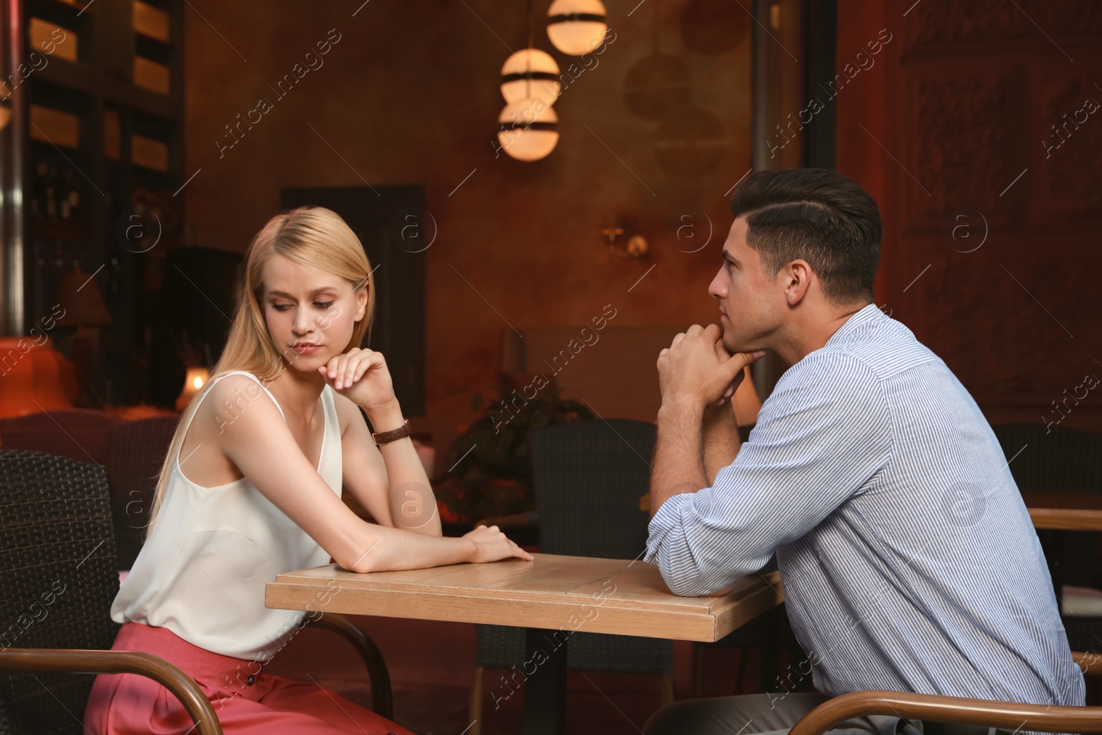 Photo of Bored couple having unsuccessful date in cafe