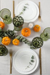 Photo of Beautiful autumn table setting. Plates, cutlery, glasses, pumpkins and floral decor, flat lay