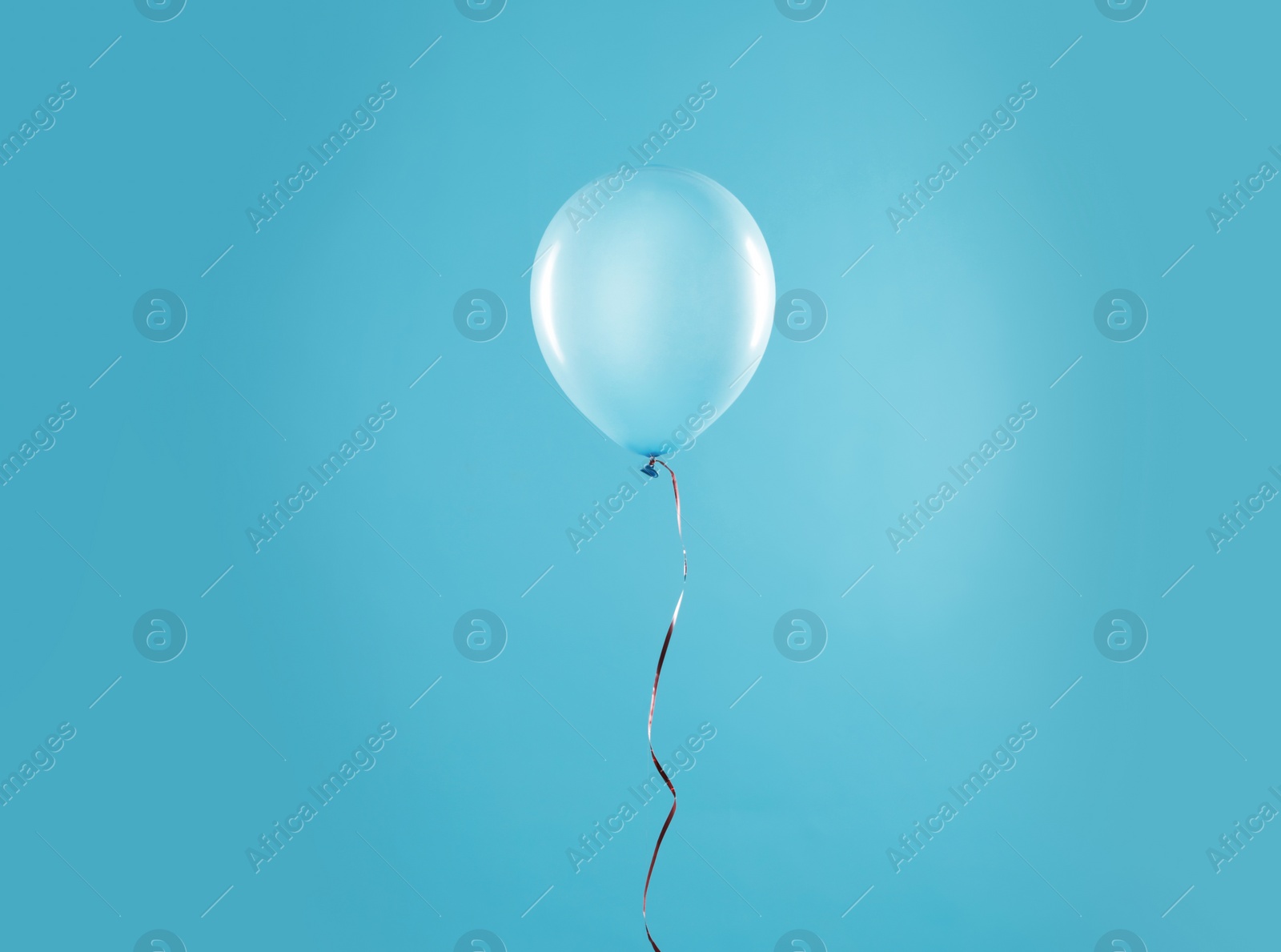 Photo of Bright balloon on color background. Celebration time