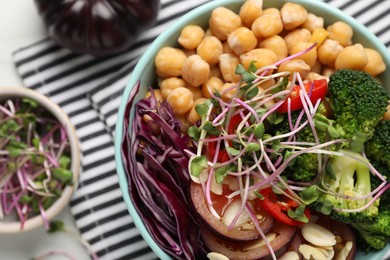 Photo of Delicious vegan bowl with broccoli, red cabbage and chickpeas on white table, flat lay