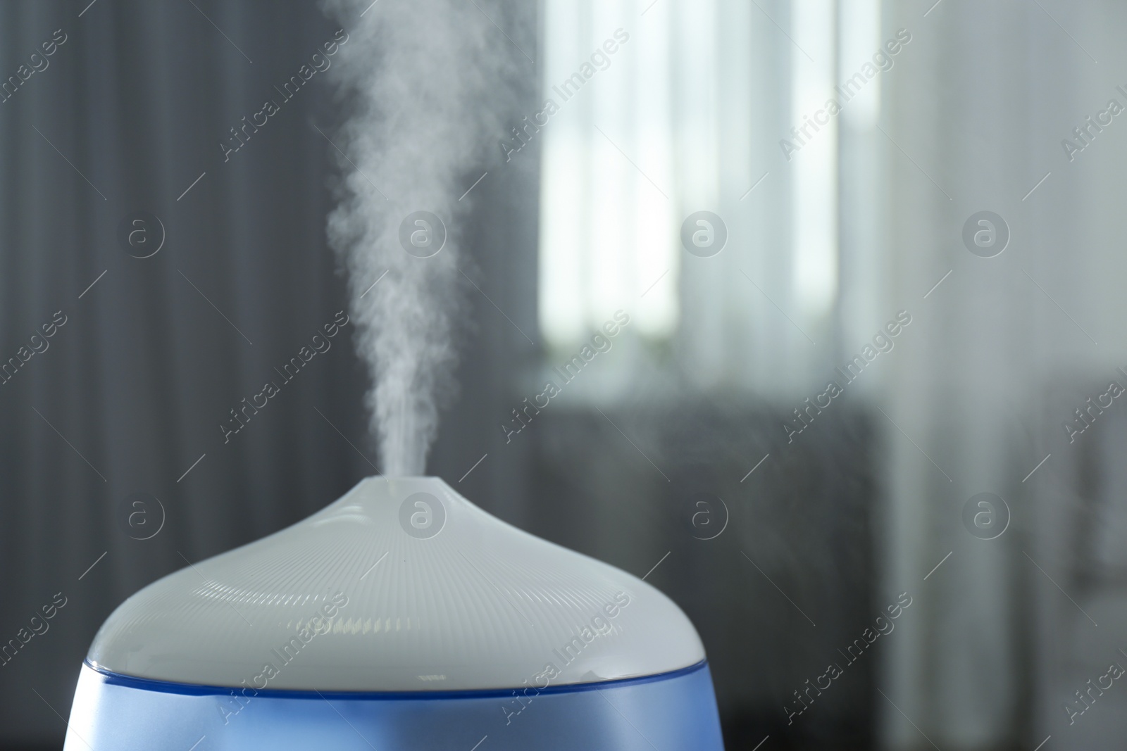 Photo of Modern air humidifier indoors, closeup. Space for text